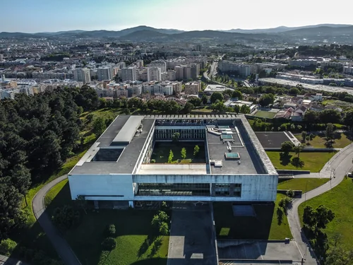Aerial view of a courtyard building with the city and hills beyond