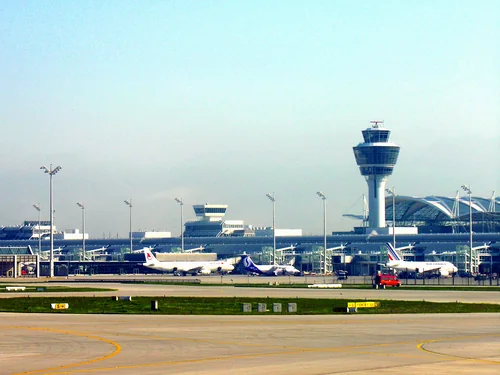 Control tower, terminal and aircraft at the gates beyond the airfield