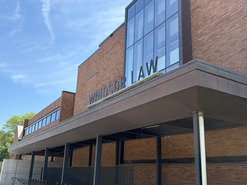 Brick façade with Windsor Law lettering above a canopy and a glazed bay